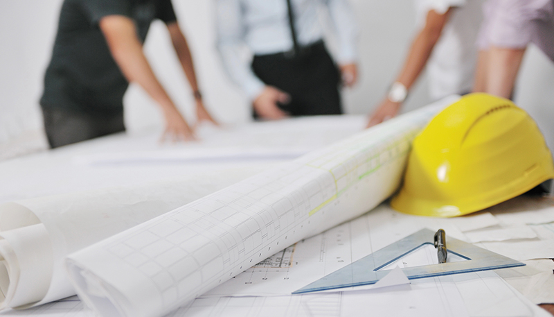 Commercial electrical contractor reviewing building plans